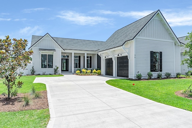 63 W Firethorn Cir Lot 65, Watersound, FL 32461 - modern inspired farmhouse with board and batten siding, a garage, roof with shingles, a front yard, and covered porch