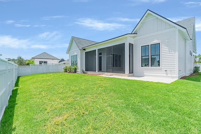 63 W Firethorn Cir Lot 65, Watersound, FL 32461 - back of property featuring a sunroom, a fenced backyard, board and batten siding, and roof with shingles