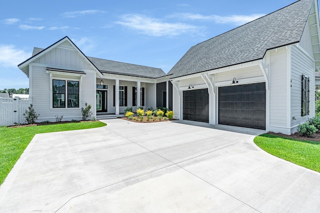 63 W Firethorn Cir Lot 65, Watersound, FL 32461 - modern inspired farmhouse featuring a porch, an attached garage, driveway, and roof with shingles