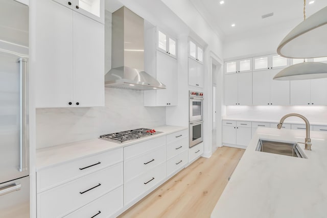 63 W Firethorn Cir Lot 65, Watersound, FL 32461 - kitchen featuring wall chimney range hood, stainless steel appliances, light wood-style floors, light countertops, and recessed lighting