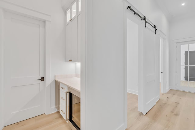 63 W Firethorn Cir Lot 65, Watersound, FL 32461 - mudroom featuring a barn door, light wood-type flooring, beverage cooler, and recessed lighting