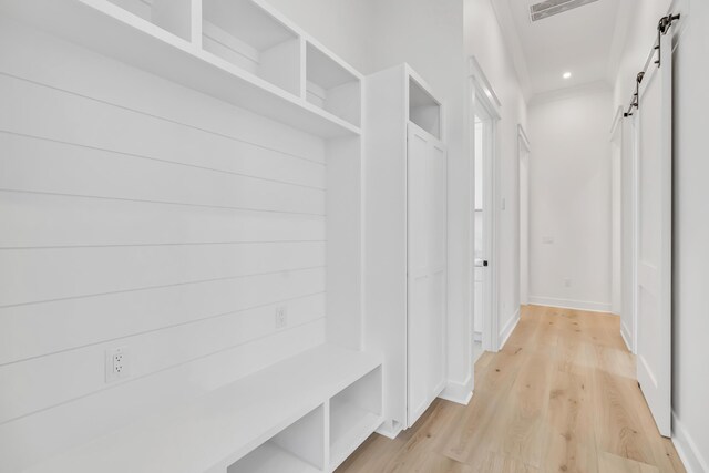 63 W Firethorn Cir Lot 65, Watersound, FL 32461 - mudroom with a barn door, light wood-style flooring, and recessed lighting
