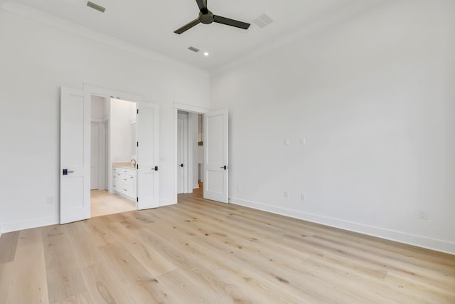 63 W Firethorn Cir Lot 65, Watersound, FL 32461 - unfurnished bedroom featuring ornamental molding, light wood-style floors, ensuite bathroom, a towering ceiling, and ceiling fan