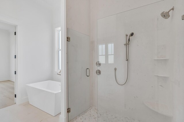 63 W Firethorn Cir Lot 65, Watersound, FL 32461 - bathroom featuring a shower stall and a soaking tub