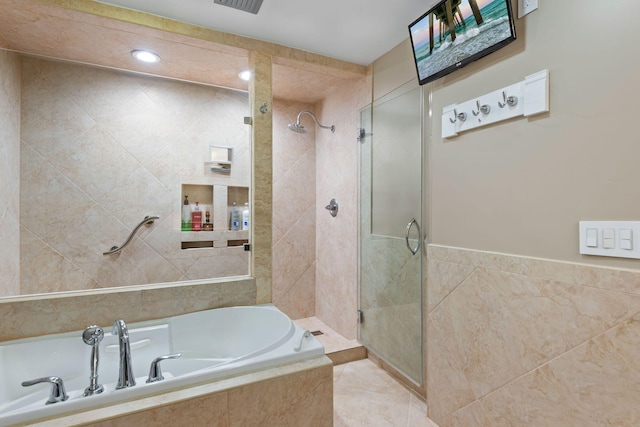 full bath with tile walls, a garden tub, and a stall shower