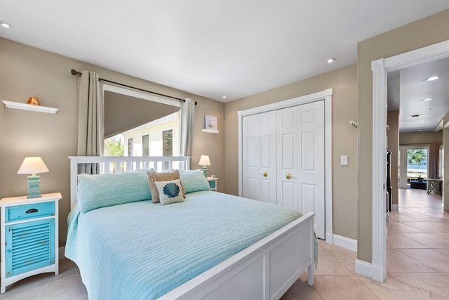 bedroom with recessed lighting, baseboards, light tile patterned floors, and a closet