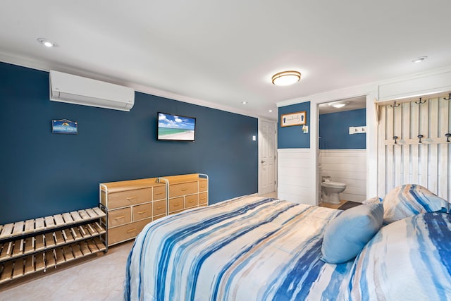 bedroom with crown molding, wainscoting, recessed lighting, a wall unit AC, and ensuite bathroom