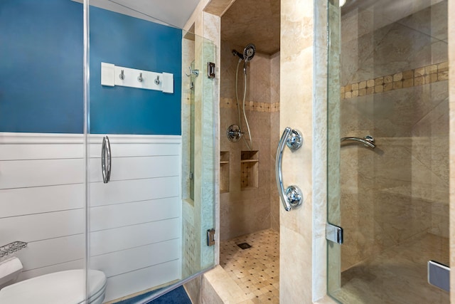 bathroom featuring a stall shower and toilet