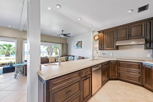 kitchen with a sink, light tile patterned floors, stainless steel dishwasher, and visible vents