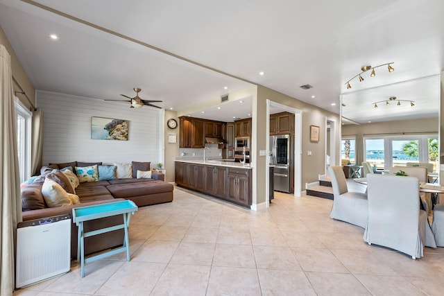 living room with light tile patterned floors, ceiling fan, recessed lighting, and visible vents