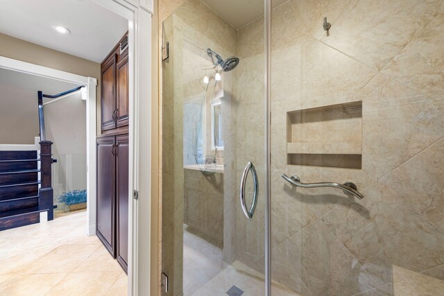bathroom featuring tile patterned flooring and a stall shower