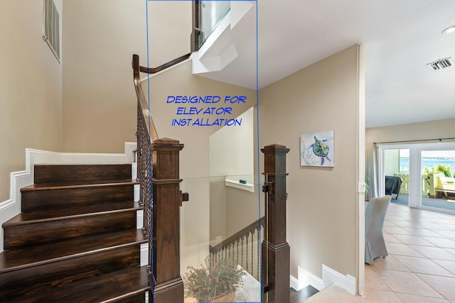 stairs featuring baseboards, visible vents, and tile patterned flooring