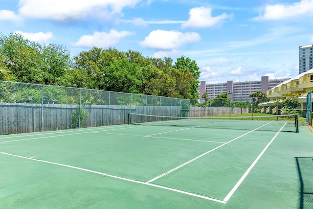 view of tennis court with fence
