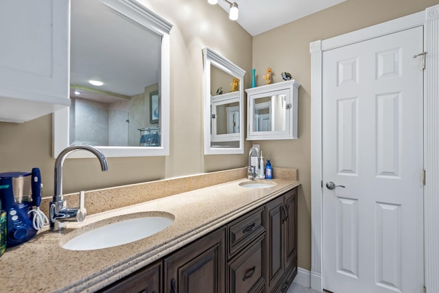 bathroom featuring a sink and double vanity