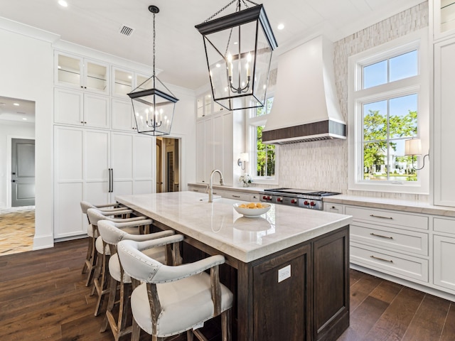 335 Churchill Oaks Dr, Santa Rosa Beach, FL 32459 - kitchen featuring stainless steel gas cooktop, a chandelier, premium range hood, dark wood-style flooring, and visible vents
