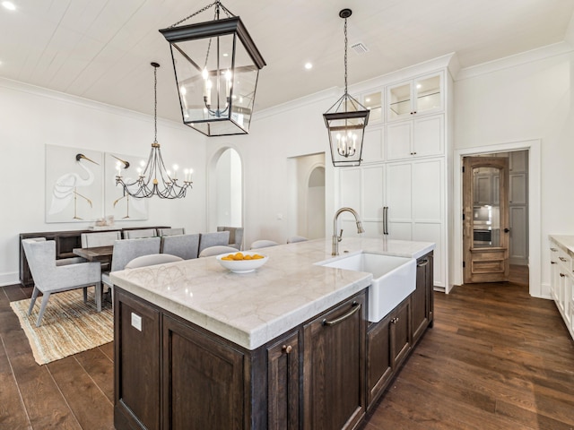 335 Churchill Oaks Dr, Santa Rosa Beach, FL 32459 - kitchen featuring arched walkways, a sink, dark brown cabinetry, a chandelier, and white cabinetry