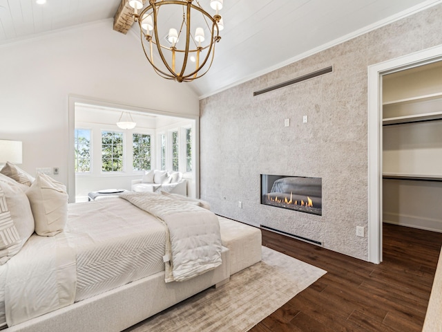 335 Churchill Oaks Dr, Santa Rosa Beach, FL 32459 - bedroom with a spacious closet, a chandelier, vaulted ceiling with beams, a tiled fireplace, and dark wood finished floors