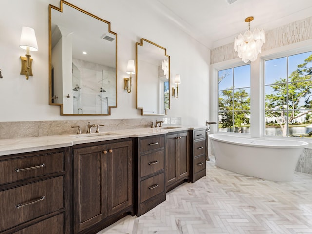 335 Churchill Oaks Dr, Santa Rosa Beach, FL 32459 - bathroom featuring a sink, a stall shower, an inviting chandelier, double vanity, and a freestanding bath