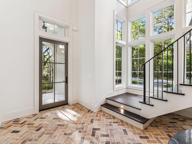 335 Churchill Oaks Dr, Santa Rosa Beach, FL 32459 - entrance foyer with a high ceiling, brick floor, and baseboards