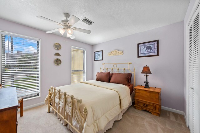 8520 Gulf Blvd # Ut-39, Navarre, FL 32566 - bedroom featuring light carpet, baseboards, a closet, a textured ceiling, and ceiling fan