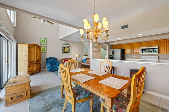 8520 Gulf Blvd # Ut-39, Navarre, FL 32566 - dining space featuring light tile patterned floors, a chandelier, a towering ceiling, a ceiling fan, and baseboards
