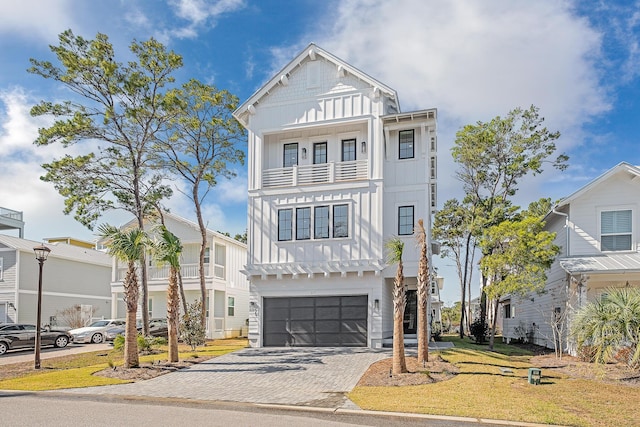 107 Grande Pointe Dr, Inlet Beach, FL 32461 - view of front of home with board and batten siding, an attached garage, decorative driveway, and a balcony