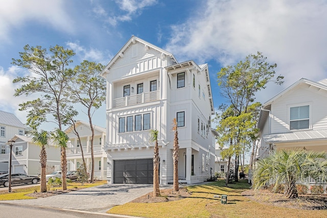 107 Grande Pointe Dr, Inlet Beach, FL 32461 - view of front of property featuring board and batten siding, a garage, a balcony, and decorative driveway
