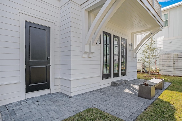 107 Grande Pointe Dr, Inlet Beach, FL 32461 - view of exterior entry featuring a patio and board and batten siding