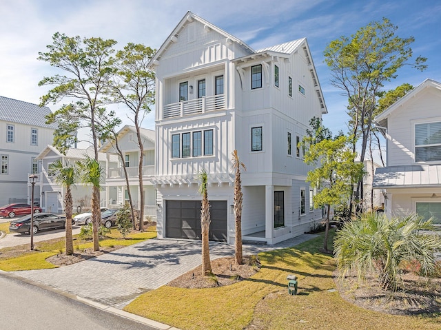 107 Grande Pointe Dr, Inlet Beach, FL 32461 - view of front of property with board and batten siding, a balcony, decorative driveway, and a garage