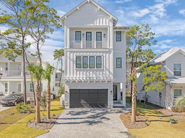 107 Grande Pointe Dr, Inlet Beach, FL 32461 - view of front of home with board and batten siding, a balcony, a garage, and decorative driveway