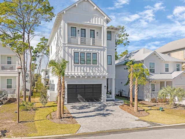107 Grande Pointe Dr, Inlet Beach, FL 32461 - view of front of house featuring a balcony, board and batten siding, a garage, and decorative driveway