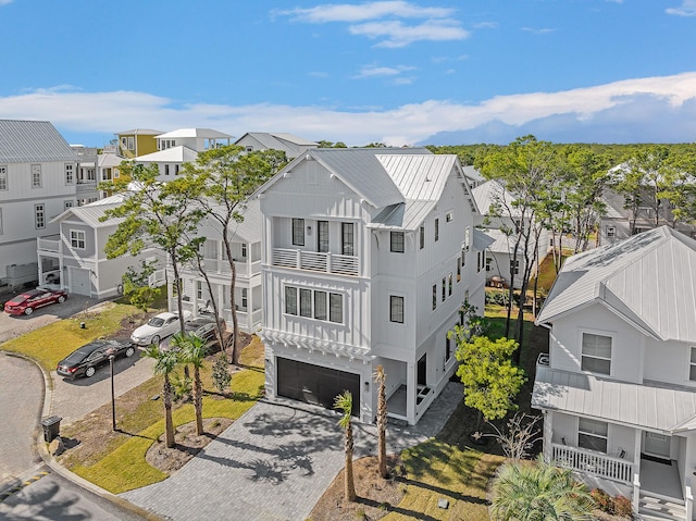 107 Grande Pointe Dr, Inlet Beach, FL 32461 - view of front facade with a residential view, a standing seam roof, metal roof, and a garage