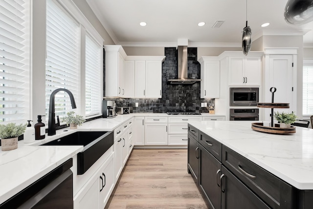 107 Grande Pointe Dr, Inlet Beach, FL 32461 - kitchen featuring stainless steel appliances, wall chimney exhaust hood, white cabinetry, a sink, and dark cabinets