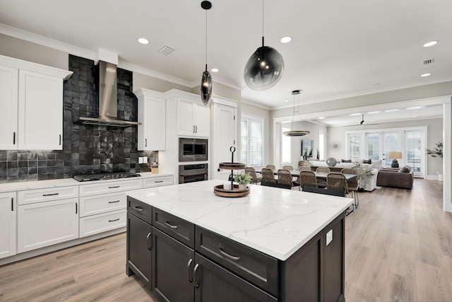 107 Grande Pointe Dr, Inlet Beach, FL 32461 - kitchen with wall chimney range hood, stainless steel appliances, white cabinets, a center island, and crown molding