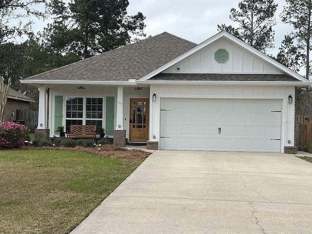 ranch-style home with fence, a front lawn, an attached garage, a shingled roof, and driveway