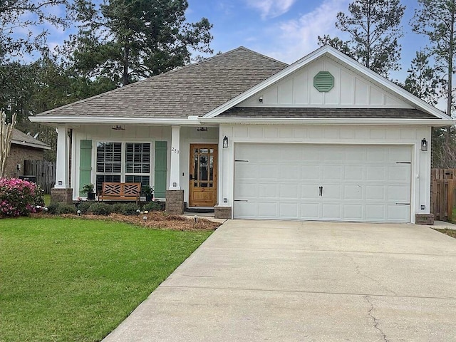 ranch-style house featuring a front lawn, board and batten siding, a shingled roof, and concrete driveway