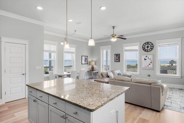 1454 Seaside Cir, Navarre, FL 32566 - kitchen featuring a center island, ornamental molding, light wood-style flooring, and ceiling fan