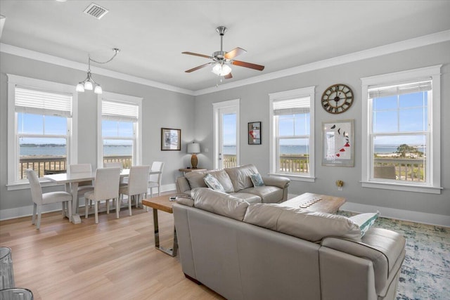 1454 Seaside Cir, Navarre, FL 32566 - living area featuring a healthy amount of sunlight, crown molding, ceiling fan, and visible vents