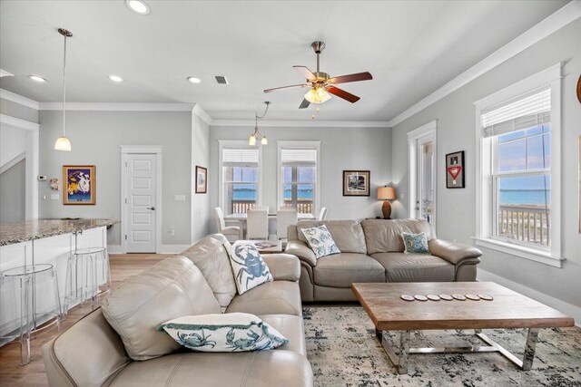 1454 Seaside Cir, Navarre, FL 32566 - living area featuring a ceiling fan, visible vents, ornamental molding, and light wood-type flooring