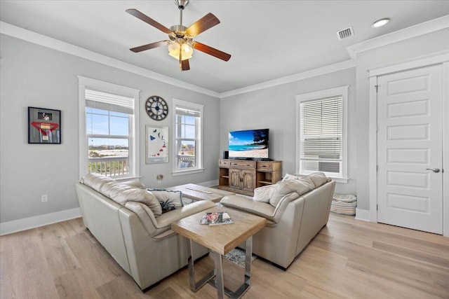 1454 Seaside Cir, Navarre, FL 32566 - living area with ceiling fan, visible vents, crown molding, baseboards, and light wood finished floors