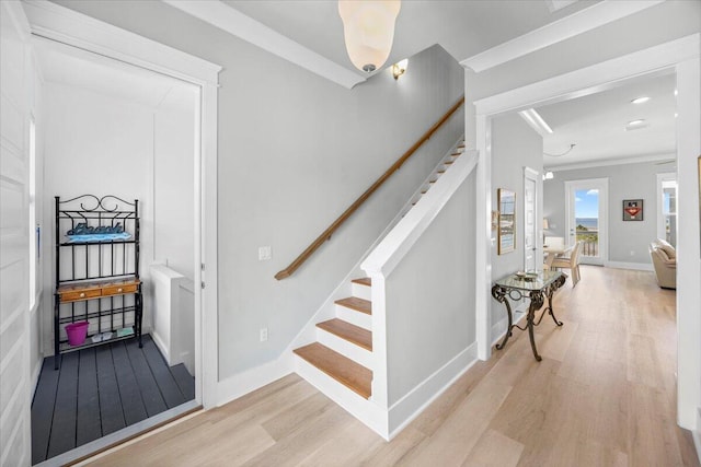 1454 Seaside Cir, Navarre, FL 32566 - staircase featuring baseboards, ornamental molding, and wood finished floors
