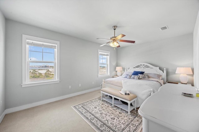 1454 Seaside Cir, Navarre, FL 32566 - bedroom featuring baseboards, visible vents, light carpet, and ceiling fan