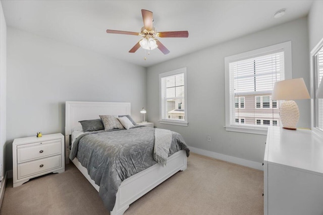 1454 Seaside Cir, Navarre, FL 32566 - bedroom with light colored carpet, baseboards, and ceiling fan