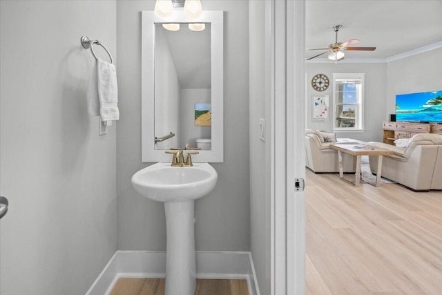 1454 Seaside Cir, Navarre, FL 32566 - bathroom featuring crown molding, baseboards, a ceiling fan, and wood finished floors