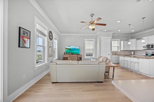 1454 Seaside Cir, Navarre, FL 32566 - living area featuring ornamental molding, a ceiling fan, and a wealth of natural light