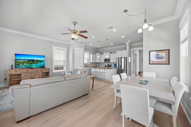 1454 Seaside Cir, Navarre, FL 32566 - dining room featuring light wood-style floors, a ceiling fan, crown molding, and recessed lighting