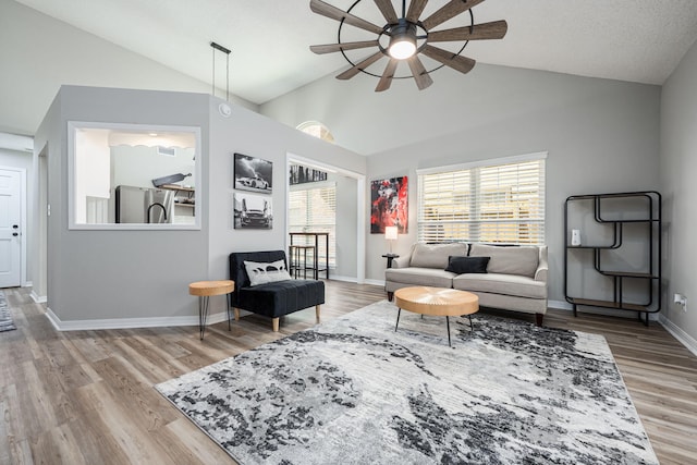 2527 Georgetown Ln, Fort Walton Beach, FL 32547 - living room featuring ceiling fan, vaulted ceiling, light wood finished floors, and baseboards