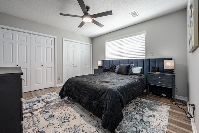 2527 Georgetown Ln, Fort Walton Beach, FL 32547 - bedroom featuring light wood-style flooring, visible vents, a textured ceiling, and two closets