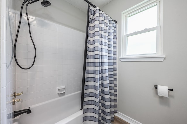 2527 Georgetown Ln, Fort Walton Beach, FL 32547 - bathroom featuring baseboards, wood finished floors, shower / bath combination with curtain, and a textured ceiling