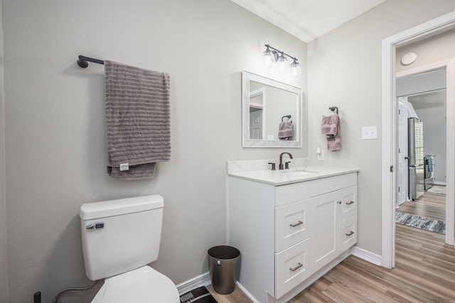 2527 Georgetown Ln, Fort Walton Beach, FL 32547 - half bath with wood finished floors, vanity, toilet, and baseboards
